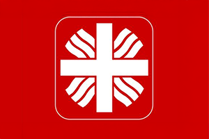 Caritaslogo vor rotem Hintergrund